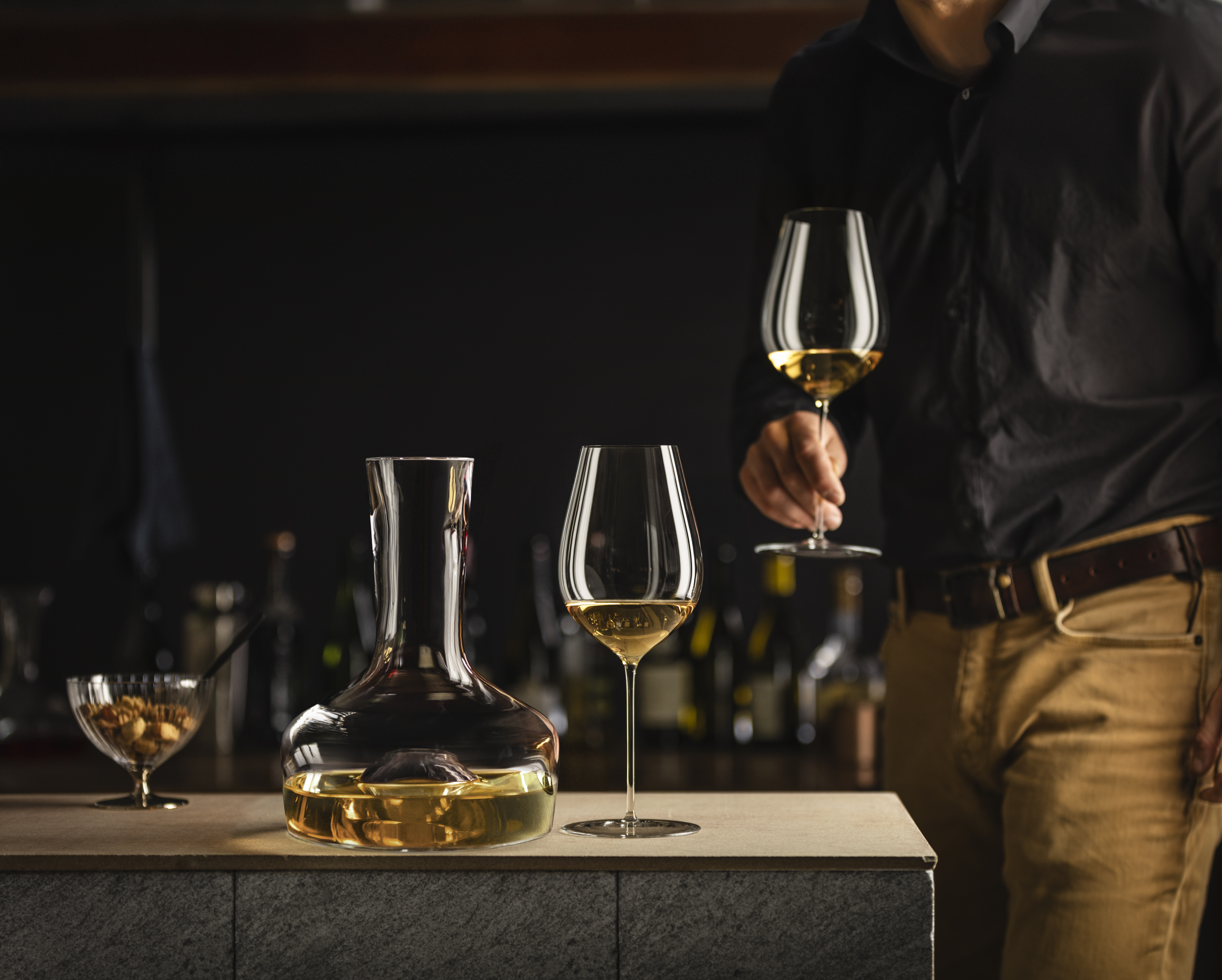 A person holding a wine glass in their hand