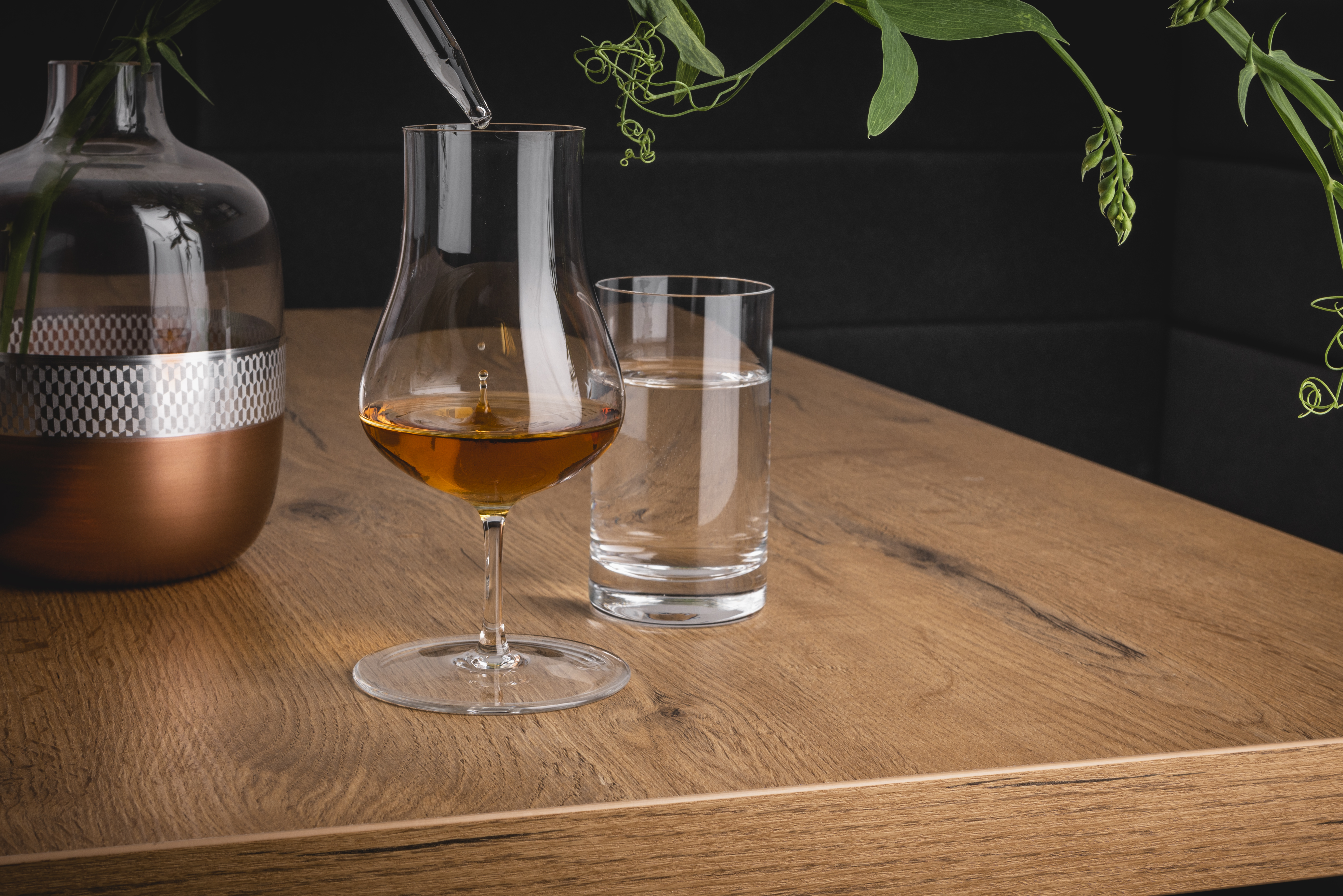 Two glasses with vase on a table