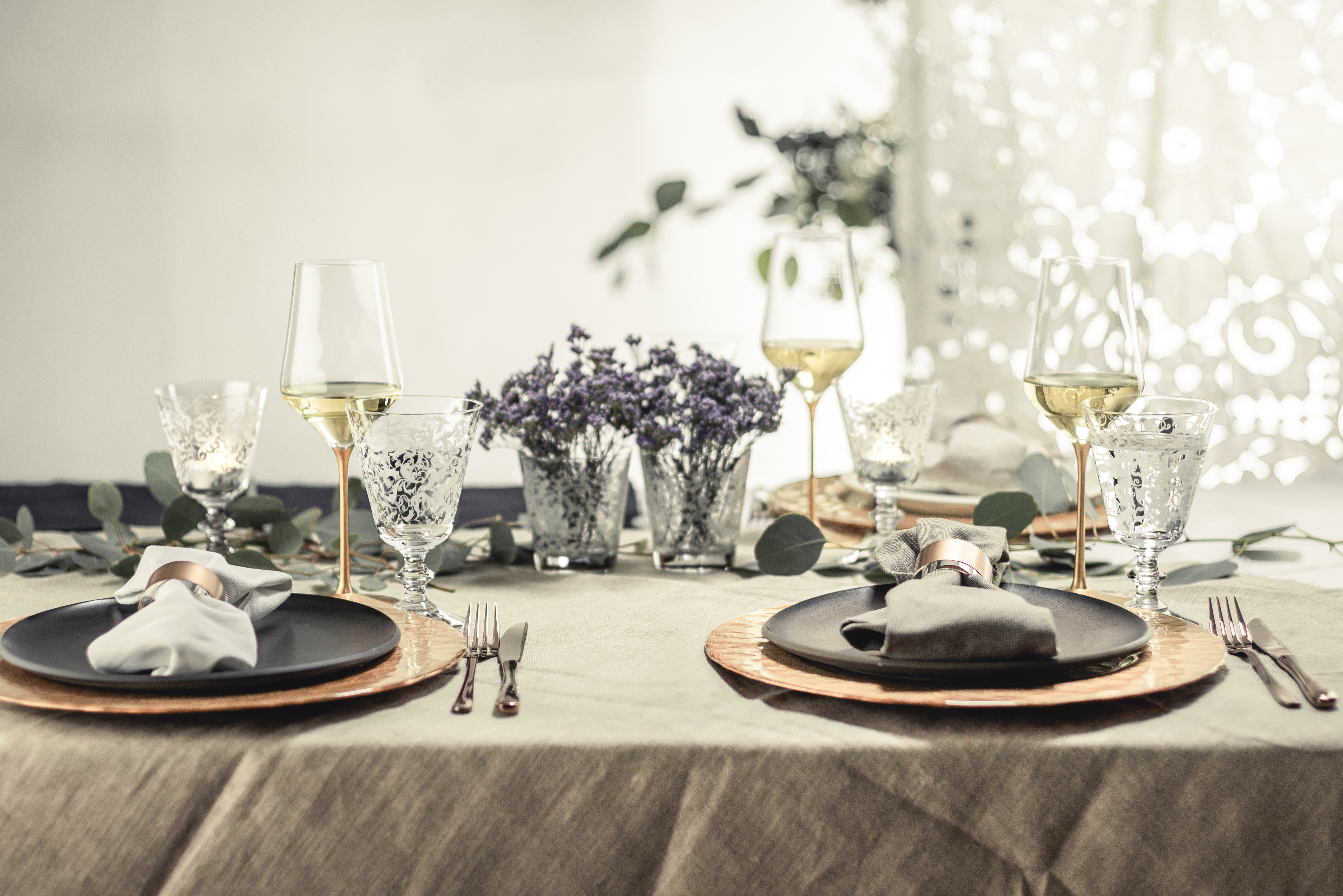 Elegantly laid table in white and copper tones